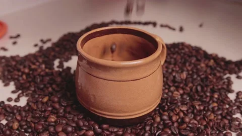 Coffee beans fall onto the table. a bunch of coffee beans. Stock Footage 142228631