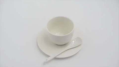 Coffee beans fall in white coffee cup on a white background, the concept of Stock Footage 134980242