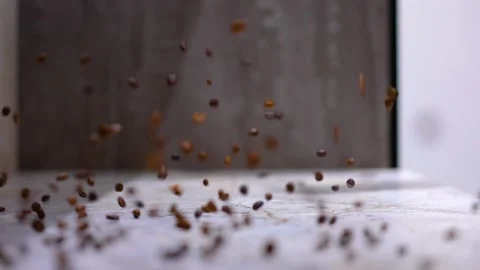 Coffee beans fall on a white table. Stock Footage 234128932