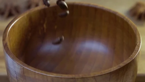 Coffee beans fall into a wooden dish. Slow motion. Stock Footage 79040844