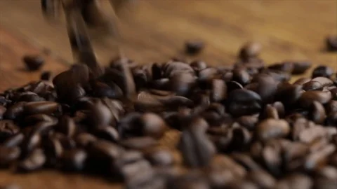 Coffee Beans Fall on a Wooden Table Closeup Stock Footage 99163340