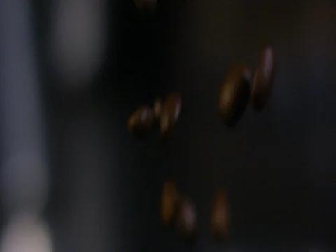 Coffee beans falling against blur background Stock Footage 83185603