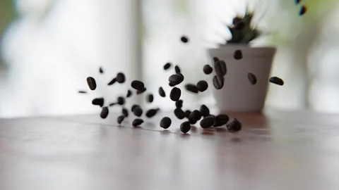 Coffee beans falling on and bouncing off of the wooden table in a 3D animatio Stock Footage 253626553