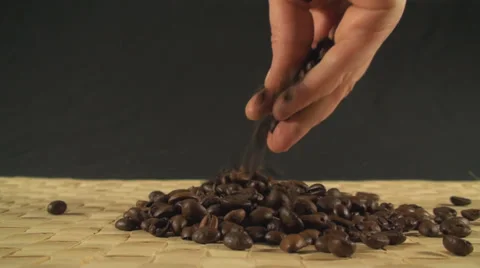 Coffee Beans Falling On A Bamboo Cover Close Up-Shot Video stock 34609600