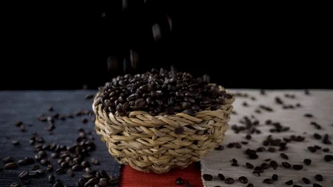 Coffee beans falling into a basket Stock Footage 115723603