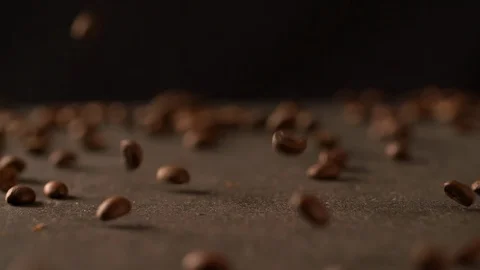 Coffee beans falling on board medium shot Slow Motion video Stock Footage 102618333