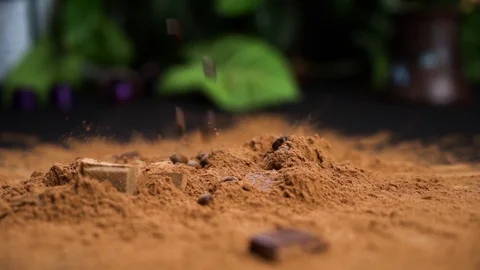 Coffee beans falling in a cacao powdre of coffee powder on a blck table. 動画素材 114035739