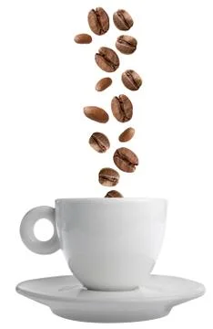 Coffee beans falling in a coffee cup Stock Photos