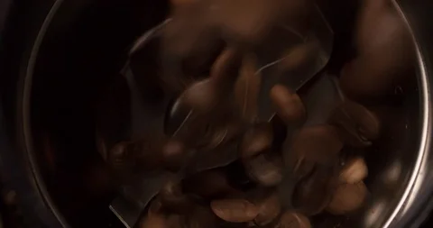 Coffee beans falling into coffee grinder close up top view Slow Motion Stock Footage 98245675