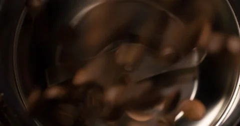 Coffee beans falling into coffee grinder extremely close up macro shot top view Stock Footage 98246258