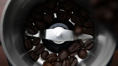 Coffee beans falling into coffee grinder machine in slow motion. Stock-Footage 126678468