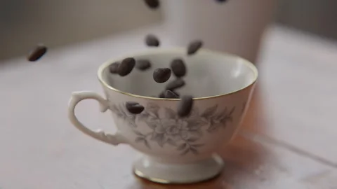 Coffee beans falling into a cup in slow motion Stock Footage 253627227