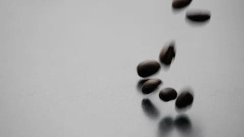 Coffee beans falling on dark background in slow motion. Stock-Footage 126678524