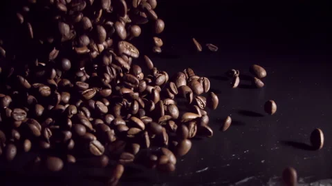 Coffee Beans falling onto dark background stone at 1000fps. Super slow motion Видео 163724188