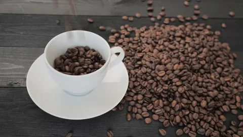 Coffee Beans falling down in a coffee cup Stock Footage 255860898