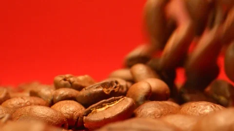 Coffee Beans Falling in Extreme Slow Motion with Red Background Stock Footage 126843923