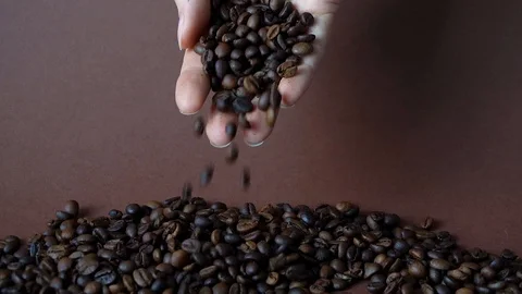 Coffee beans falling from a female hand. Aroma arabica Stock Footage 114905013
