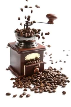Coffee beans falling into grinder isolated Stock Photos