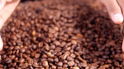 Coffee beans falling from a hand. 스톡 동영상 122057058