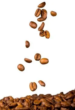 Coffee beans falling on heap of coffee, isolated on white Stock Photos