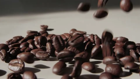 Coffee beans falling on a light  surface. Stock Footage 237194362