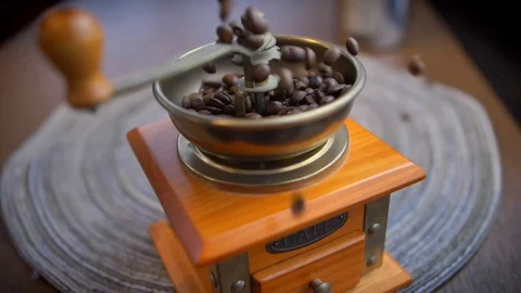 Coffee Beans Falling into Old Manual Coffee Grinder Slow Motion Stock Footage 118495891