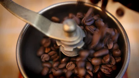 Coffee Beans Falling into Old Manual Coffee Grinder Stock Footage 118534906
