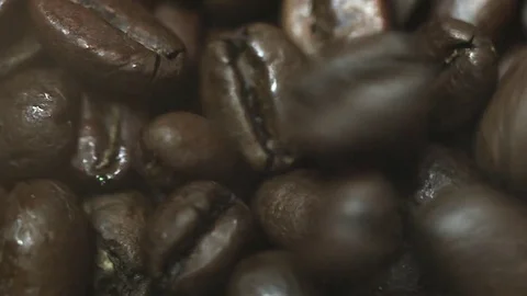 Coffee beans falling onto other beans. macro shot , Full HD Stock Footage 72513081