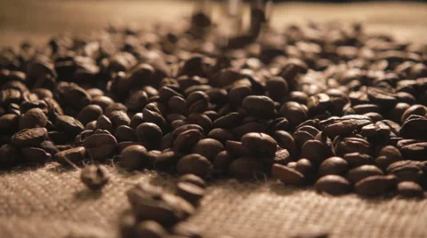 Coffee beans falling onto sacking in slow motion Stock Footage 55370111