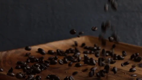 Coffee Beans Falling on Spinning Wood Plate Stock Footage