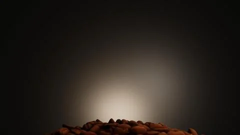 Coffee beans falling with spotlight from the back Stock Illustration