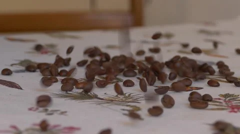 Coffee beans falling onto table cloth Stock Footage 46980368