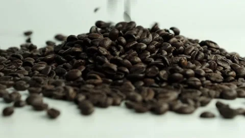 Coffee beans falling on table in slow motion. Stock Footage 149593539