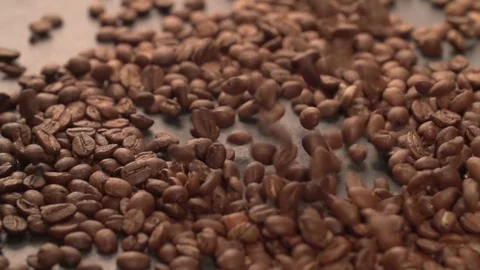 Coffee beans falling on table surface Slow motion Stock Footage 107941149