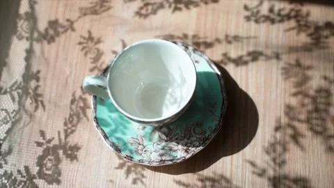 Coffee beans falls on a table in the beautiful cup. There is a beautiful shadow Stock Footage 133820411