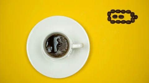 Coffee beans fill white cup. Battery indicates full charge. Stop motion Video stock 124431644