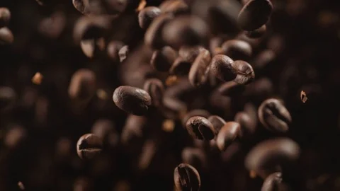 Coffee beans fly after being exploded. Slow Motion. Stock Footage