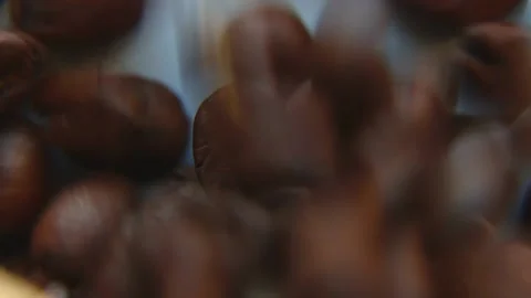 The coffee beans fly away and there remains one coffee bean that rotates Stock Footage 239944353