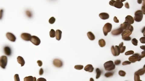Coffee beans fly in slow motion on the white background Video stock 148552675