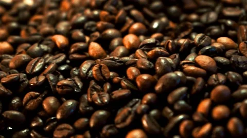 Coffee beans in the foreground rotating Stock Footage 148386745
