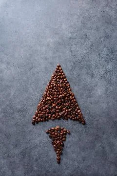 Coffee beans in a form of an arrow 库存照片