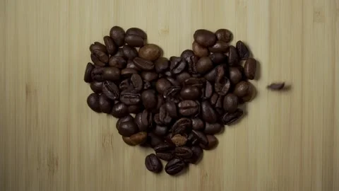 Coffee beans forming heart in slow motion Stock Footage 217896720