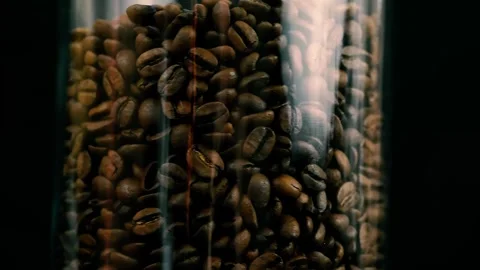 Coffee beans in a glass jar texture rotating macro footage 4k Stock Footage 252030386