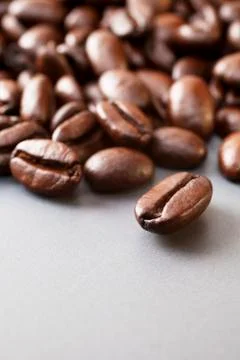 Coffee beans on grey ceramic surface Stock Photos