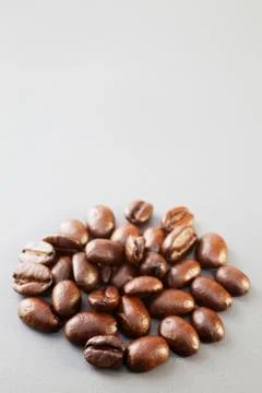 Coffee beans on grey ceramic surface Stock Photos