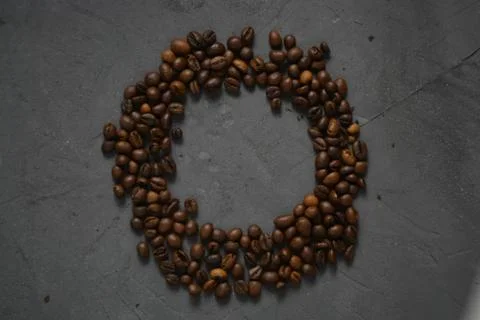 Coffee beans on a grey surface Stock Photos