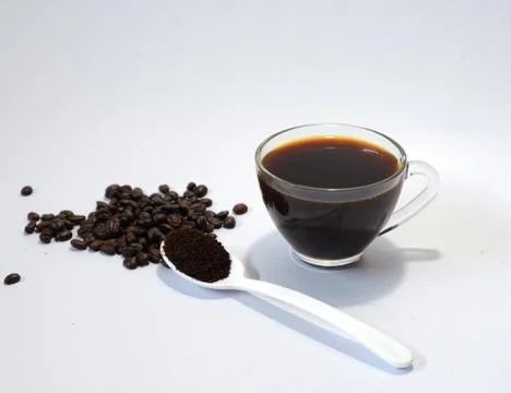 Coffee beans, ground coffee, black coffee in a glass on a white background Stock Photos