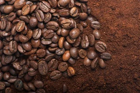 Coffee beans with ground coffee Stock Photos
