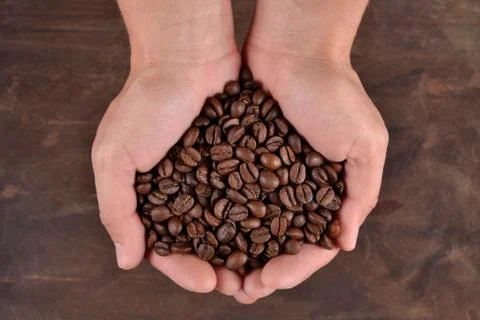 Coffee beans in the hands Stock Photos