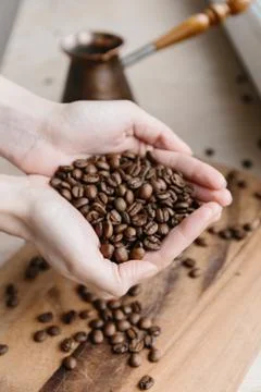 Coffee beans in hands Stock Photos